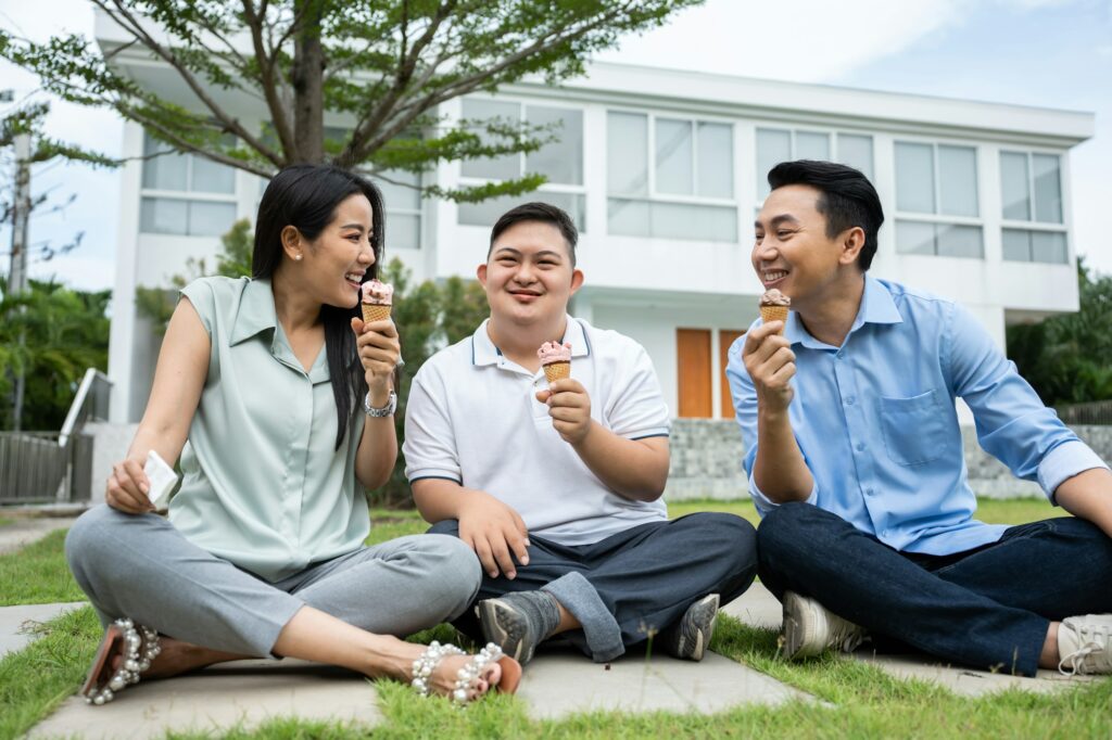Asian attractive family, parents playing with young son in the garden.